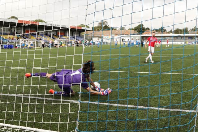 Tom Roxborough pulls off the Challenge Cup winning penalty shoot-out save for AC Copnor against AFC Tamworth. Picture by Kevin Shipp