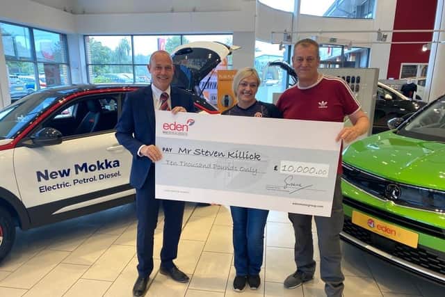 Left to right; Ian Simpson, branch manager, Steven Killick and his wife at Eden Vauxhall Fareham