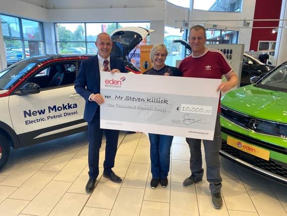 Left to right; Ian Simpson, branch manager, Steven Killick and his wife at Eden Vauxhall Fareham