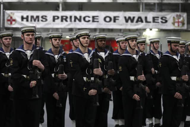 Pictured is sailors presenting the Royal Salute during the commissioning of HMS Prince of Wales. Photo: Royal Navy