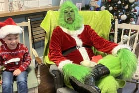 Coco’s Coffee Shop, located in Fareham, has organised a meet and greet event where children had the opportunity to meet The Grinch and Max. 
Pictured: Riley (4) from Fareham with the Grinch at Coco’s coffee shop.