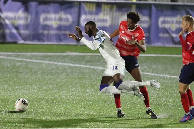 Mo Faal is sent tumbling following a  Sido Jombati challenge, but Hawks' shouts for a penalty were waved away. Picture by Dave Haines