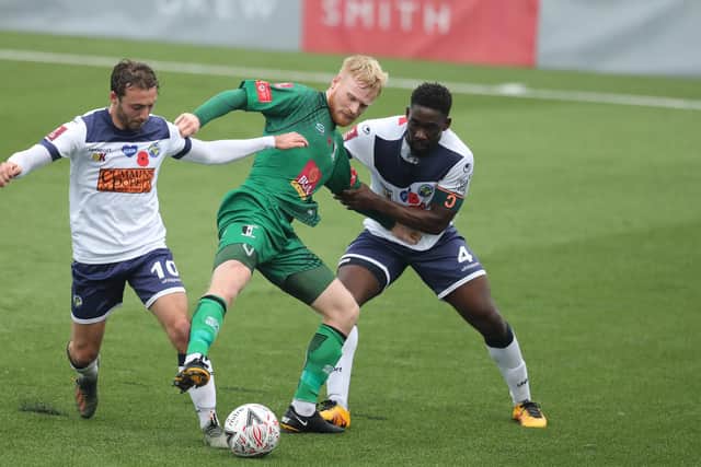 Cray's Matthew Warren battles with Hawks pair Joe Iaciofano and Godfrey Poku. Photo by Dave Haines