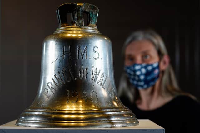 Victoria Ingles, senior curator at the National Museum of the Royal Navy, looks at the ship's bell from HMS Prince of Wales which was sunk along with HMS Repulse after a Japanese air attack on December 10 1941. 842 men lost their lives in what is one of the worst disasters in British naval history. Picture date: Wednesday December 8, 2021.