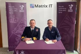 Nic Cronin (right) signing the Armed Forces Covenant