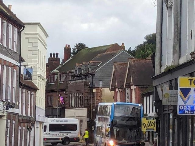 Firefighters fixing loose roof tiles and a sign above Poppins Cafe in North Street, Havant, on January 2.