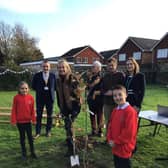 Staff and pupils at Alverstoke Church of England Junior School celebrate their connection with, Kitoo Primary School with a tree planting ceremony on Friday 2 December, joined by Gosport MP Dame Caroline Dinenage.