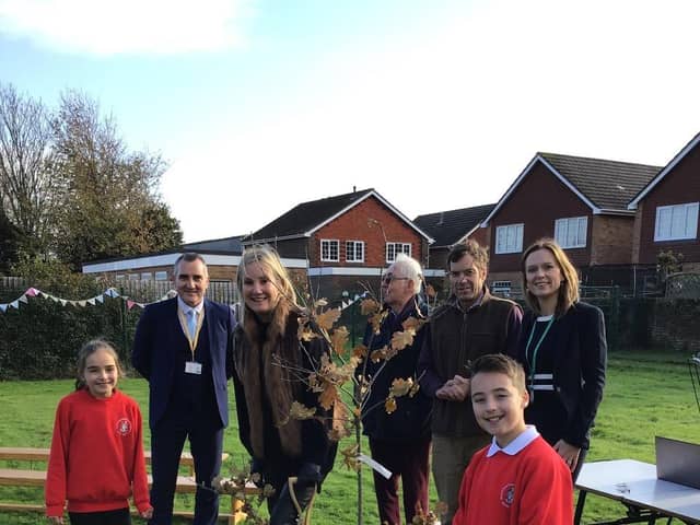 Staff and pupils at Alverstoke Church of England Junior School celebrate their connection with, Kitoo Primary School with a tree planting ceremony on Friday 2 December, joined by Gosport MP Dame Caroline Dinenage.