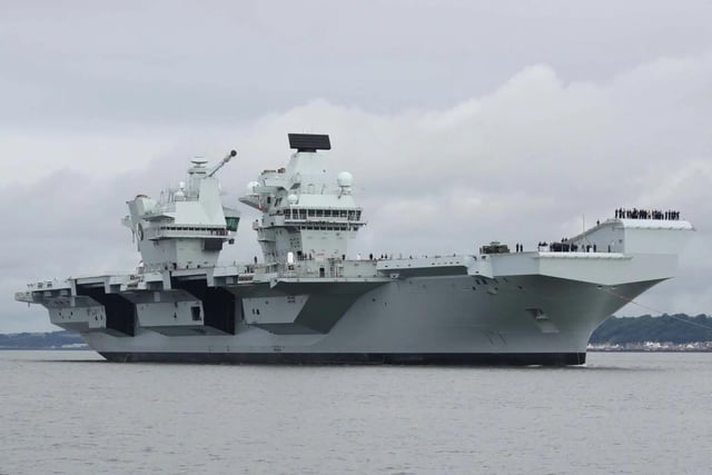 HMS Queen Elizabeth leaving Rosyth in Fife, Scotland, and sailing under the Forth bridge. She is due to return home to Portsmouth on July 30.