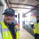 Mark Lewis and his helper completing a mural on Gosport hoardings