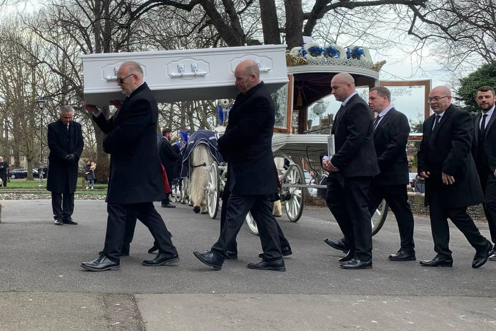Ace Rewcastle's coffin is carried into St Mary's Church in Fratton today 
Picture: Sarah Standing