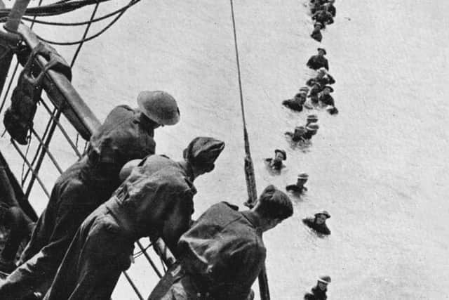 Troops pictured evacuating the beaches of Dunkirk for a Royal Navy warship 80 years ago.