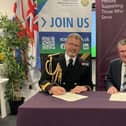 Surgeon Commodore Stuart Collett and Dr John Black sign the Armed Forces Covenant