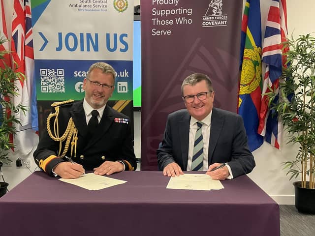 Surgeon Commodore Stuart Collett and Dr John Black sign the Armed Forces Covenant