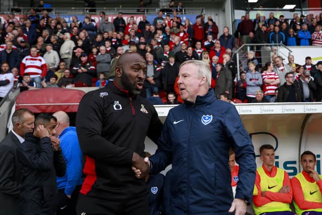 Donncaster boss Darren Moore shakes hands with Pompey manager Kenny Jackett. Picture: Daniel Chesterton