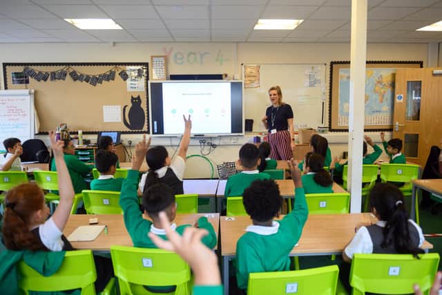 Teacher Ruth Titmus leads a maths class for Year Four children in their classroom at Greenacres Primary Academy in Oldham, northern England on September 02, 2020. - Millions of children across England have returned to school this week after the Covid-19 lockdown with many schools introducing measures to enable as safe an environment as possible. Education Secretary Gavin Williamson said that the return of pupils to schools in England this week will be a 'massive milestone'. (Photo by Oli SCARFF / AFP) (Photo by OLI SCARFF/AFP via Getty Images)