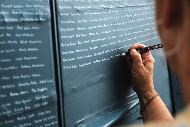 Names being written on the NHS spitfire that will fly over Queen Alexandra Hospital in Portsmouth on Saturday at 3.05pm. Picture: George Romain