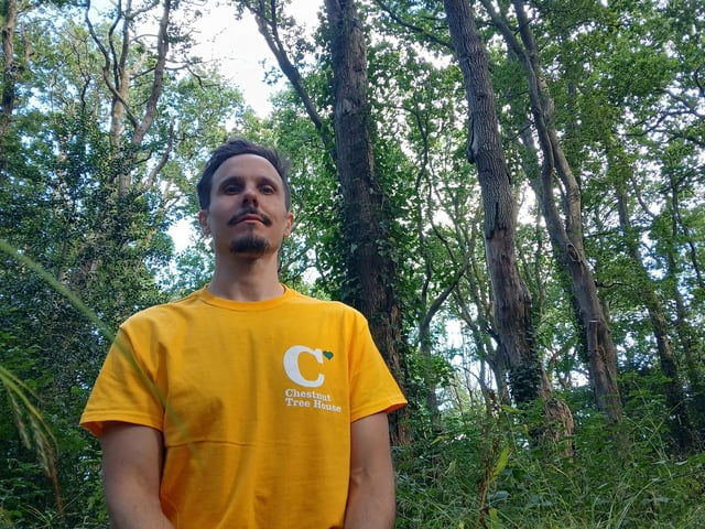 Kyle, 38 from Portsmouth sat in the woods of Wecock Farm, where he currently lives