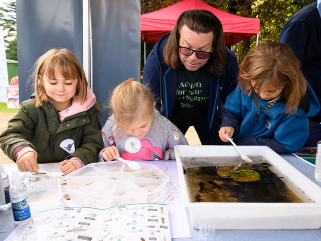 Pictured is: Neil form Western Rivers Trust teaches Alex, Esme and Alice about pond life Picture: Keith Woodland (140921-108)