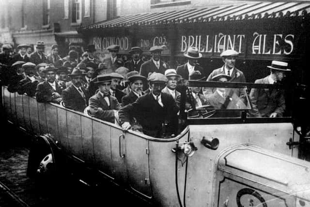 A charabanc bus sets off on an outing from the Royal Arms in Gosport in 1920