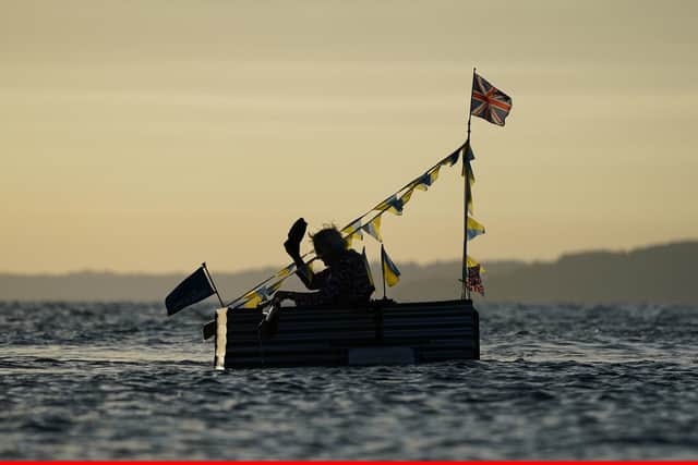 Michael Stanley, known as 'Major Mick', raises his cap as he sets off in his boat Tintanic II to row across the Solent from Hurst Castle towards the Isle of Wight, as part of his Tintanic charity challenge.