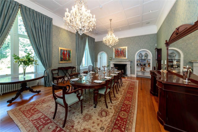 The dining room has a decorative ceiling pattern, with an impressive open fireplace, as well as exposed timber flooring and traditional sash and case windows with a mirroring archway that leads to the drawing room