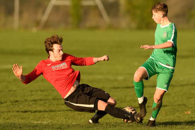 Action from Wymering (red) v Cowplain in the Mid Solent Adult League this season. Picture: Keith Woodland