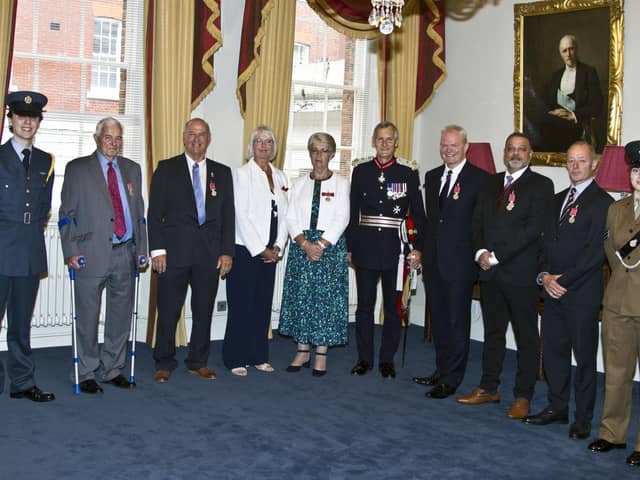 Malcolm Dent, third left, and Andrew Wing, second right, at their BEM presentation ceremony. Picture by Tony Knight.