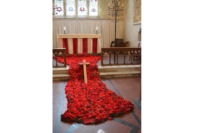 The cascade of poppies inside St Michael and All Angels' Church, Chalton, as part of the ‘Remembering’ exhibition.
