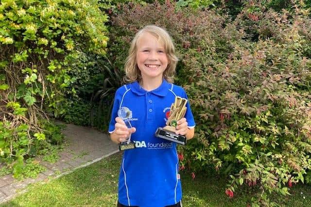 Ray Reynolds, nine, with his South East Hampshire Indoor Cricket League trophies following a successful 2019/20 season