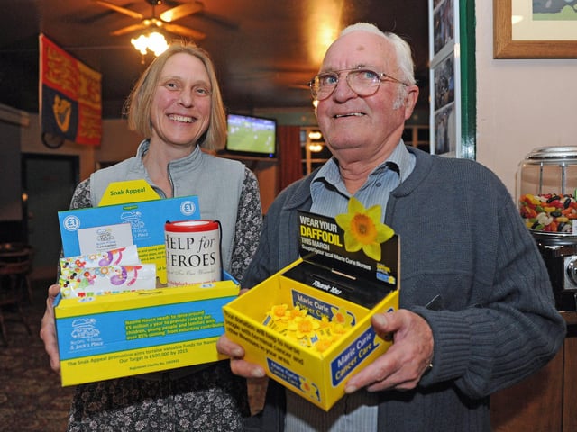 Landlady Pia Ewens and former landlord from 1988-1995 Brian Broad, pictured in 2012 with some of the sweets and daffodils the pub was selling for charity (120989-2973)