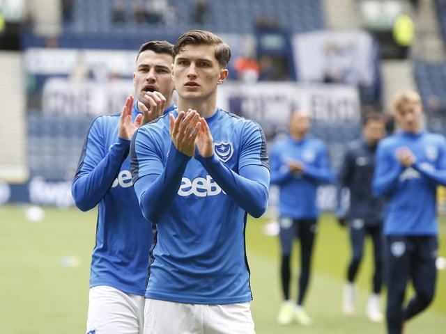 Freddie Potts and Regan Poole applaud the Pompey fans in the away end at Deepdale before kick-off.