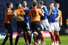 Ronan Curtis and Oxford's John Mousinho were at the centre of an argument after the final whistle of last night's 1-1 draw. Picture: Joe Pepler