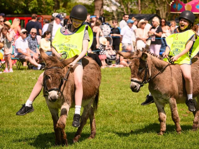 Two young riders having a great time at the Hayling Island Donkey Derby.Picture: Keith Woodland (250521-41)
