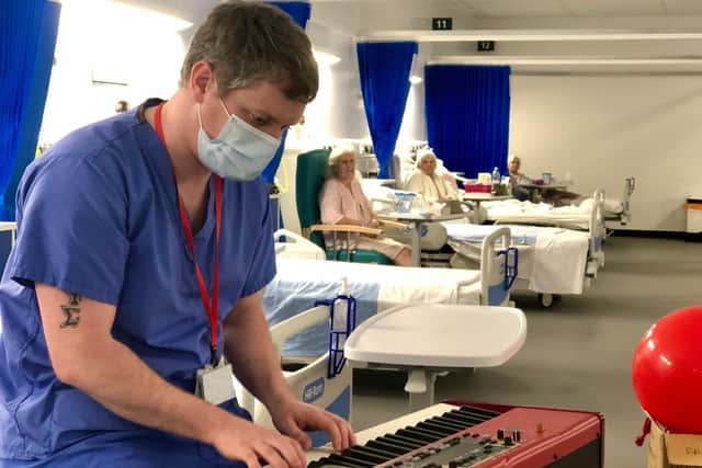 Patients enjoy listening to a performance from a member of the Royal Marines Band.