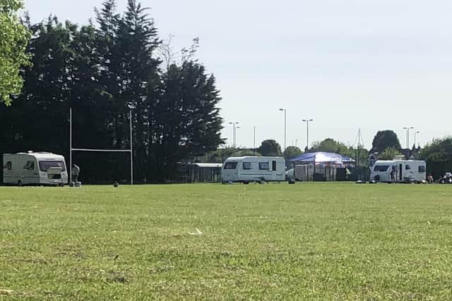 Travellers on the playing field at Portsmouth Rugby Football Club.