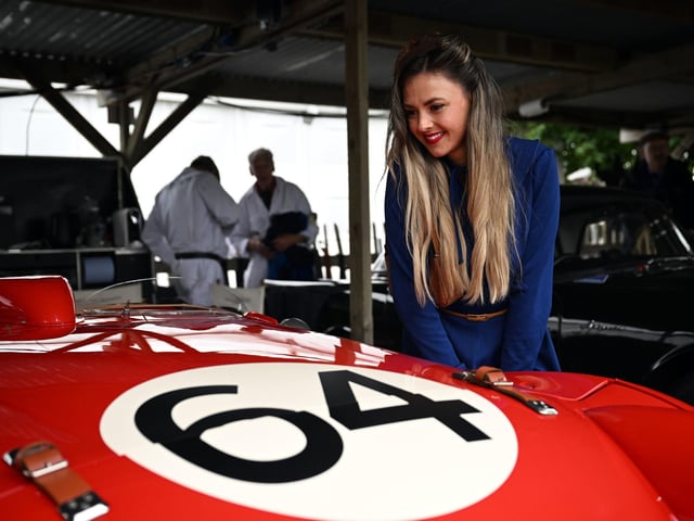 Race meet goers enjoy the classic cars on show at at Goodwood Revival. Photo: John Nguyen/PA Wire