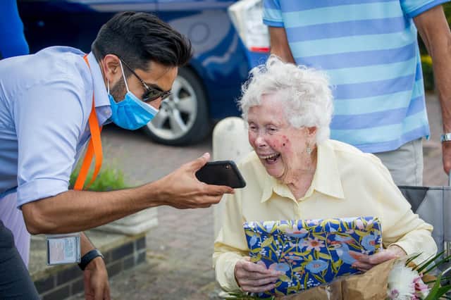 Iris watches the video message from tennis and snooker stars with Kev Popat, from Right at Home Solent. Picture: Habibur Rahman