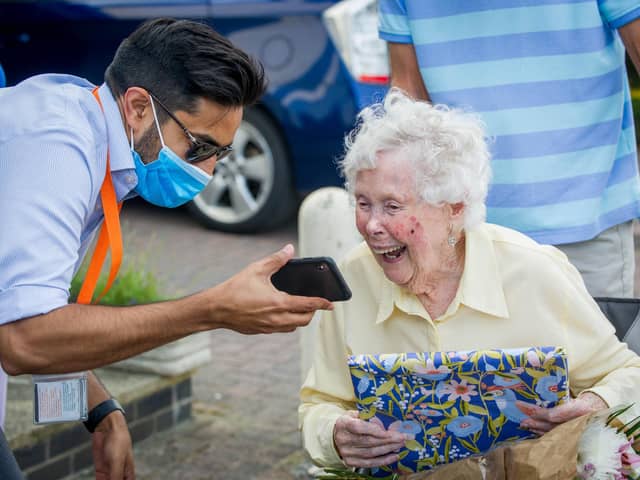 Iris watches the video message from tennis and snooker stars with Kev Popat, from Right at Home Solent. Picture: Habibur Rahman