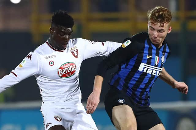 SESTO SAN GIOVANNI, ITALY - FEBRUARY 20: Ndary Michel Adopo of Torino FC competes for the ball with Tibo Persyn of FC Internazionale during the Supercoppa Primavera match between FC Internazionale U19 and Torino FC U19 at Stadio Breda on February 20, 2019 in Sesto San Giovanni, Italy.  (Photo by Marco Luzzani/Getty Images for Lega Serie A)