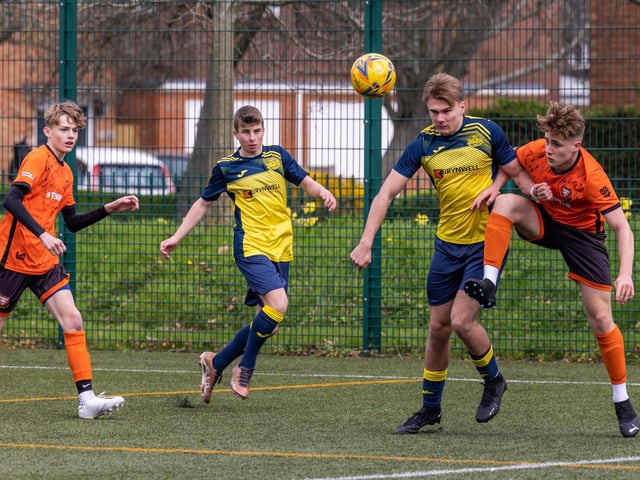 Action from the 2-2 draw between the under-18s of Moneyfields (blue/yellow kit) and AFC Portchester (orange/black kit). Picture: Mike Cooter