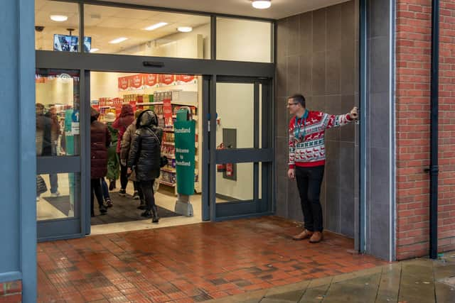 Tim Benham (Store Manager) opens the new Poundland store in West Street, Fareham. Picture: Mike Cooter (091223)