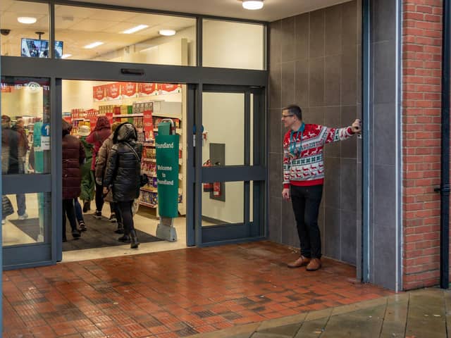 Tim Benham (Store Manager) opens the new Poundland store in West Street, Fareham. Picture: Mike Cooter (091223)