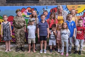 Margaret Lowther with some of the children from the neighbourhood in front of the new mural. Picture: Emily Turner
