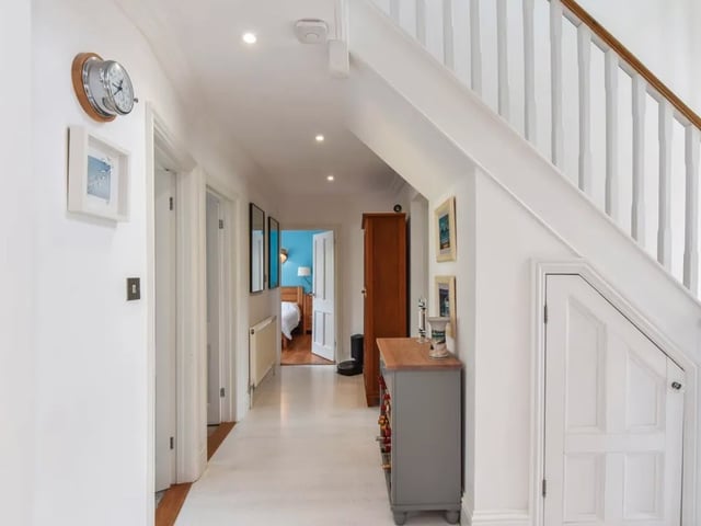 The listing says: "The ground floor consists of a sitting room featuring log burner and under floor heating, huge open plan kitchen dining area, with under floor heating and bi-folds that open up onto the gardens."