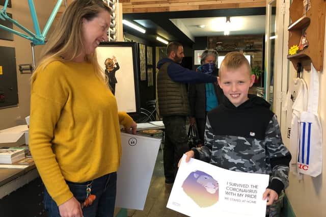 Excited art-lover Dexter Farrow, eight, collects his prize. He is pictured with Sally Eveleigh, 43, of Southsea. Photo: Tom Cotterill