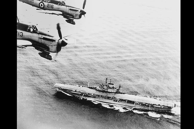 HMS Illustrious. Fairey Firefly nightfighters overfly the carrier in the early 1950's.