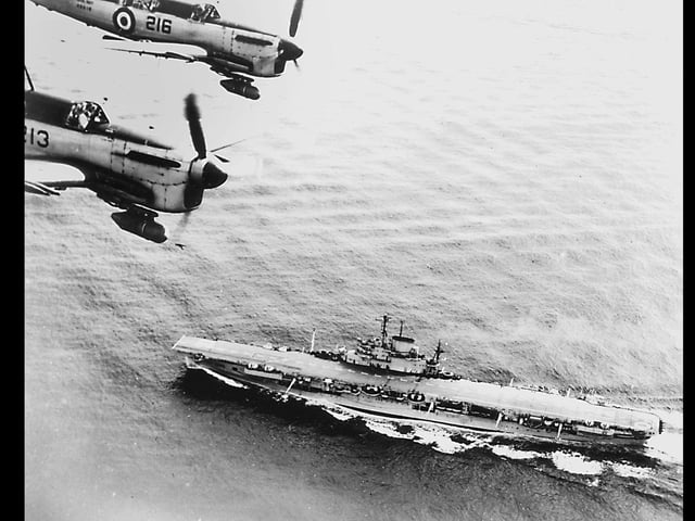 HMS Illustrious. Fairey Firefly nightfighters overfly the carrier in the early 1950's.
