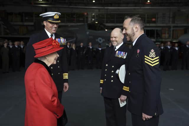 Queen Elizabeth II presents the 15 years long service and good conduct medal to Petty Officer Matthew Ready (right) during a visit to HMS Queen Elizabeth at HM Naval Base, Portsmouth, ahead of the ship's maiden deployment. The visit comes as HMS Queen Elizabeth prepares to lead the UK Carrier Strike Group on a 28-week operational deployment travelling over 26,000 nautical miles from the Mediterranean to the Philippine Sea. Picture: Steve Parsons/PA Wire