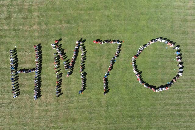 Pupils of Woodcroft Primary School, Waterlooville spelling the letters and numbers 'HM70'